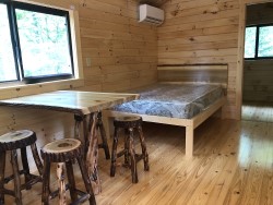 Main room with queen bed and dinette